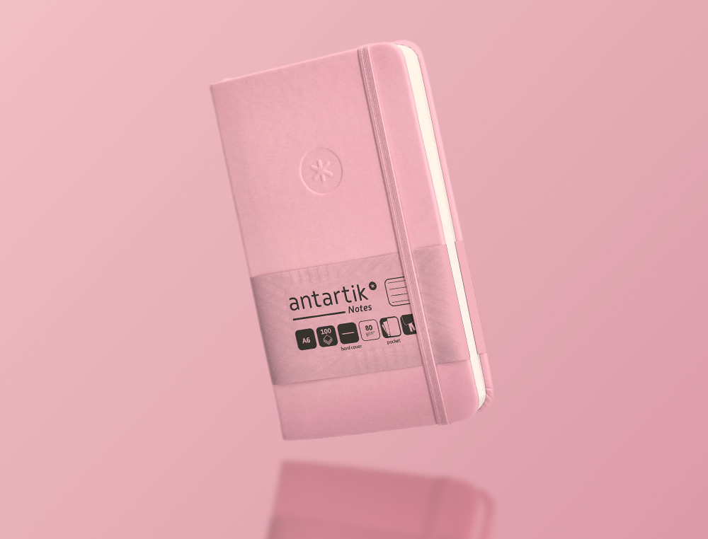 CUADERNO CON GOMILLA ANTARTIK NOTES TAPA DURA A6 HOJAS RAYAS ROSA PASTEL 100 HOJAS 80 GR FSC